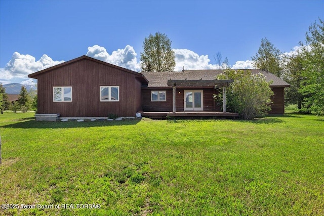 7302 Lakeside Rd, Victor, ID 83455 - ranch-style house with a deck and a front lawn
