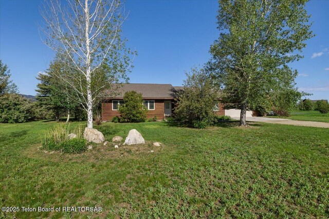 7302 Lakeside Rd, Victor, ID 83455 - view of front of house featuring a front yard and driveway