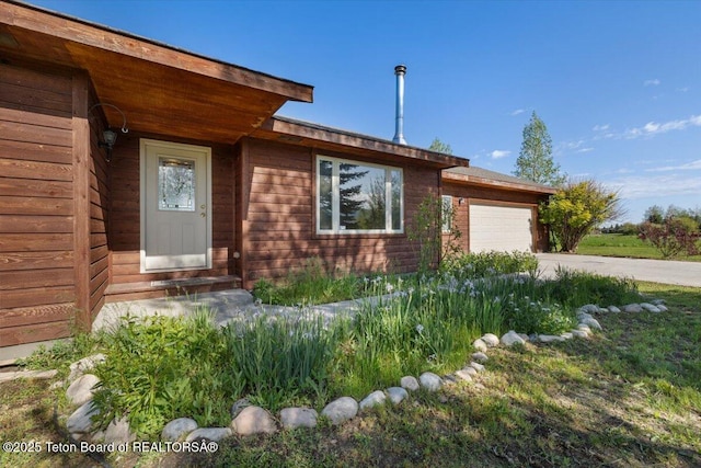 7302 Lakeside Rd, Victor, ID 83455 - view of front of property with an attached garage and concrete driveway