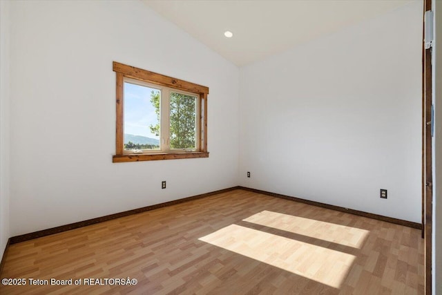 7302 Lakeside Rd, Victor, ID 83455 - unfurnished room featuring vaulted ceiling, light wood-style flooring, and recessed lighting