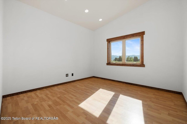 7302 Lakeside Rd, Victor, ID 83455 - spare room featuring light wood finished floors, vaulted ceiling, and recessed lighting