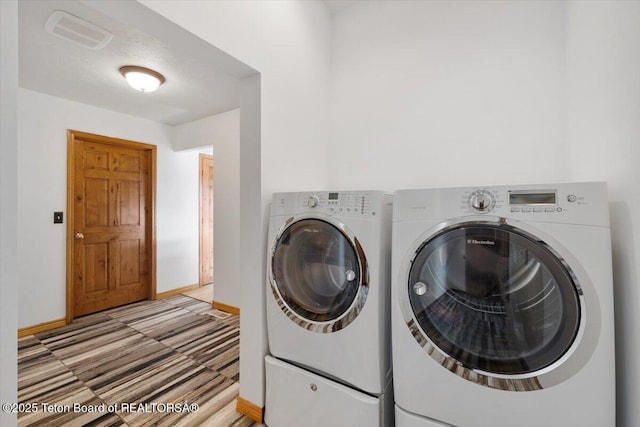 7302 Lakeside Rd, Victor, ID 83455 - laundry room with washing machine and clothes dryer and baseboards