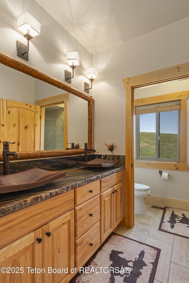 1802 Dusty Trl, Auburn, WY 83111 - full bathroom with vanity and stone tile floors