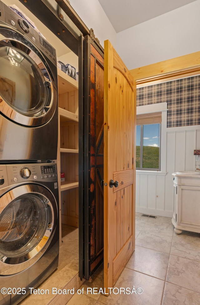 1802 Dusty Trl, Auburn, WY 83111 - laundry room with stacked washer and clothes dryer and tile patterned floors