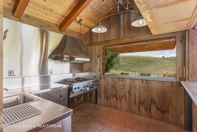 1802 Dusty Trl, Auburn, WY 83111 - kitchen with stainless steel countertops, premium range hood, wooden walls, stovetop, and wood ceiling