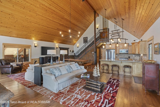 1802 Dusty Trl, Auburn, WY 83111 - living room with high vaulted ceiling, stairs, wood-type flooring, and a wood ceiling with exposed beams