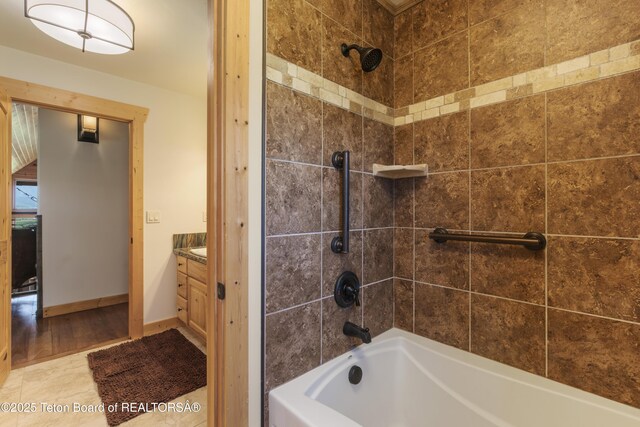 1802 Dusty Trl, Auburn, WY 83111 - bathroom featuring bathtub / shower combination, vanity, and wood finished floors