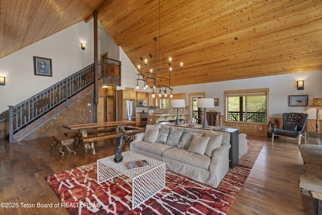 1802 Dusty Trl, Auburn, WY 83111 - living room featuring hardwood / wood-style floors, a chandelier, high vaulted ceiling, a wood ceiling with exposed beams, and stairs