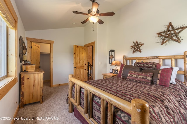 1802 Dusty Trl, Auburn, WY 83111 - bedroom with light colored carpet, lofted ceiling, a walk in closet, and a ceiling fan