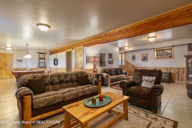 1802 Dusty Trl, Auburn, WY 83111 - living area with wood walls, a wainscoted wall, and light tile patterned floors