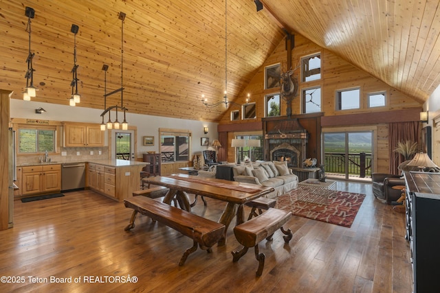 1802 Dusty Trl, Auburn, WY 83111 - dining area with high vaulted ceiling, a fireplace, hardwood / wood-style floors, and a wood ceiling with exposed beams
