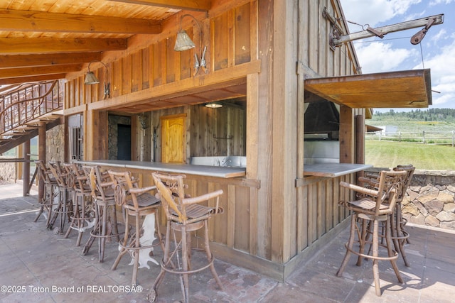 1802 Dusty Trl, Auburn, WY 83111 - indoor bar with stairs and beamed ceiling