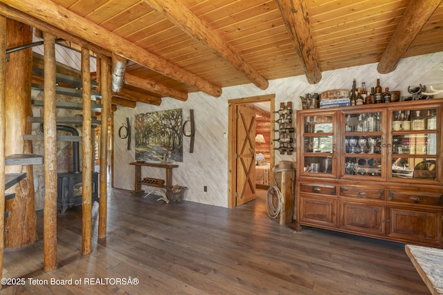 1169 N 6500 N, Tetonia, ID 83452 - dining room featuring dark wood finished floors, a wooden ceiling with exposed beams, a wood stove, and wooden walls