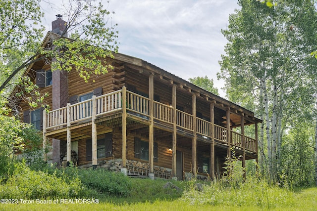 4821 S 2000 E, Victor, ID 83455 - back of property featuring a chimney, a deck, and log exterior