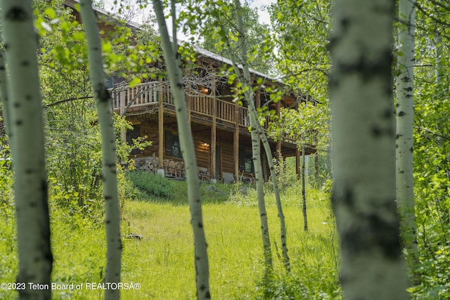 4821 S 2000 E, Victor, ID 83455 - rear view of property with a wooden deck and log veneer siding