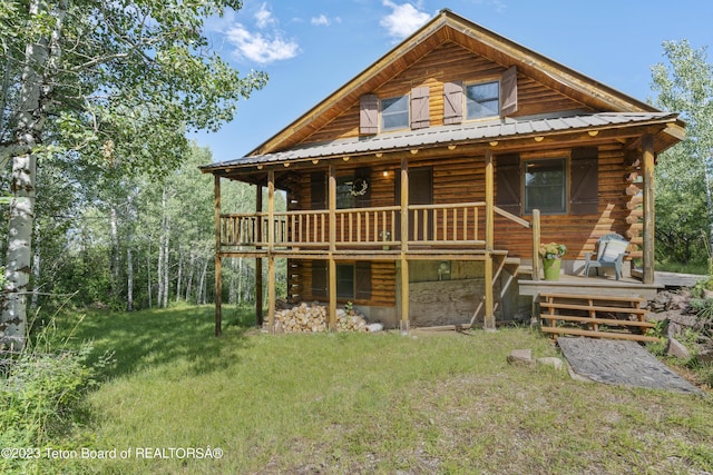 4821 S 2000 E, Victor, ID 83455 - view of front of home with a metal roof, log siding, a front lawn, and a deck