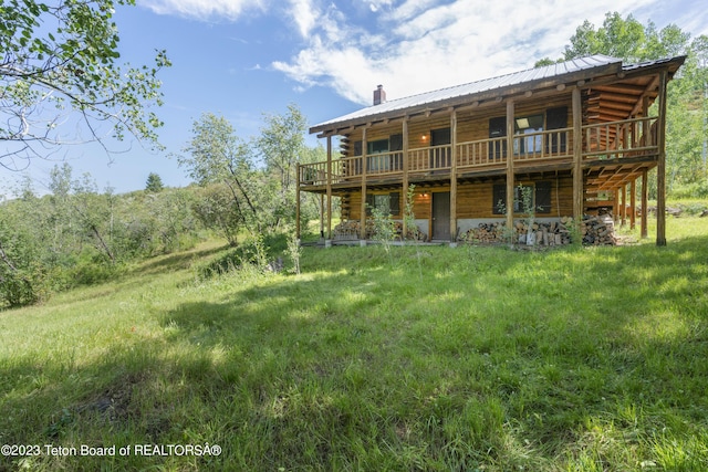 4821 S 2000 E, Victor, ID 83455 - back of house with log exterior, a deck, a chimney, and a metal roof
