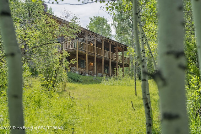 4821 S 2000 E, Victor, ID 83455 - rear view of house featuring a deck and faux log siding