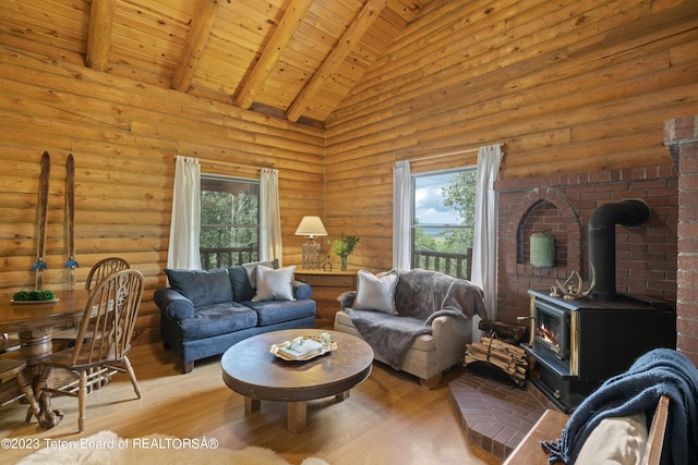4821 S 2000 E, Victor, ID 83455 - living area featuring a wood stove, wood finished floors, a wood ceiling with exposed beams, and high vaulted ceiling