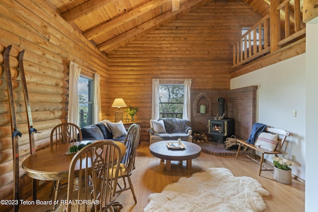 4821 S 2000 E, Victor, ID 83455 - living room featuring a wood stove, healthy amount of natural light, high vaulted ceiling, a wood ceiling with exposed beams, and wood finished floors