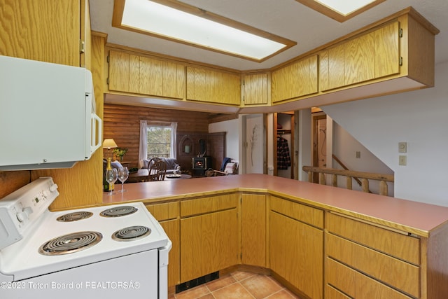 4821 S 2000 E, Victor, ID 83455 - kitchen with white appliances, light countertops, a peninsula, light tile patterned floors, and a wood stove