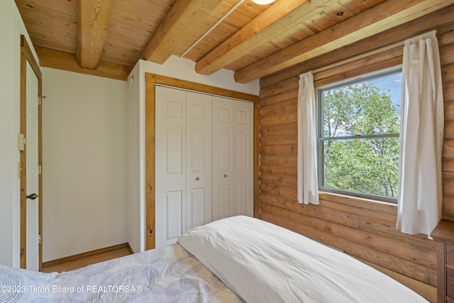 4821 S 2000 E, Victor, ID 83455 - bedroom featuring log walls, a wooden ceiling with exposed beams, and a closet