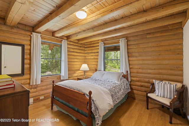 4821 S 2000 E, Victor, ID 83455 - bedroom with a wood ceiling with exposed beams, light wood finished floors, and log walls