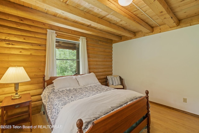 4821 S 2000 E, Victor, ID 83455 - bedroom featuring a wooden ceiling with exposed beams, log walls, and wood finished floors