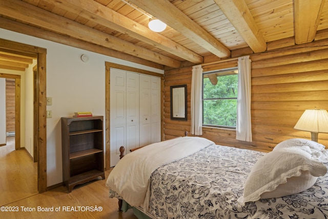 4821 S 2000 E, Victor, ID 83455 - bedroom featuring a wood ceiling with exposed beams, light wood-style flooring, a closet, and rustic walls