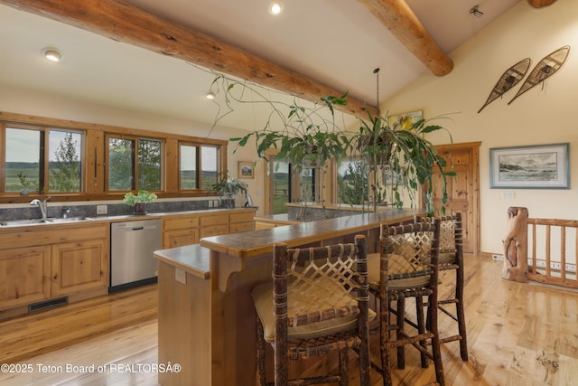 73657339 Summer Breeze Trl, Tetonia, ID 83452 - kitchen featuring dishwasher, beamed ceiling, a kitchen breakfast bar, light wood-type flooring, and dark countertops