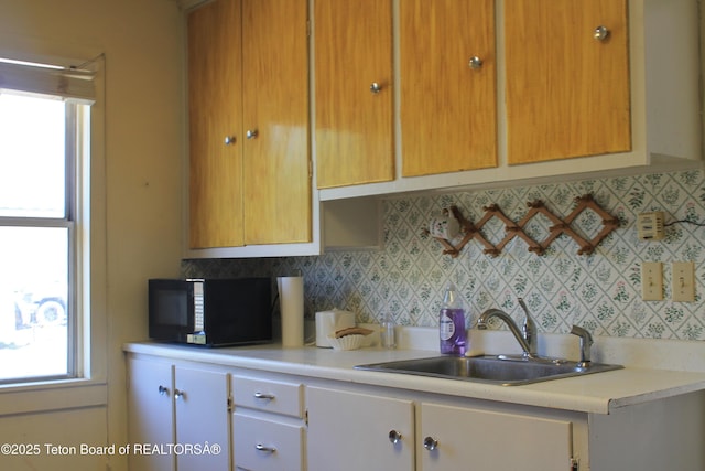 216 E Birch St, Labarge, WY 83123 - kitchen with black microwave, light countertops, and plenty of natural light