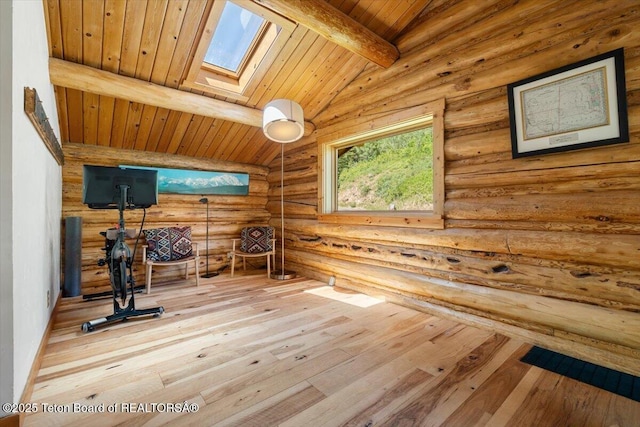 6250 W Paintbrush Trl, Wilson, WY 83014 - exercise room with a skylight, log walls, hardwood / wood-style flooring, lofted ceiling, and wooden ceiling