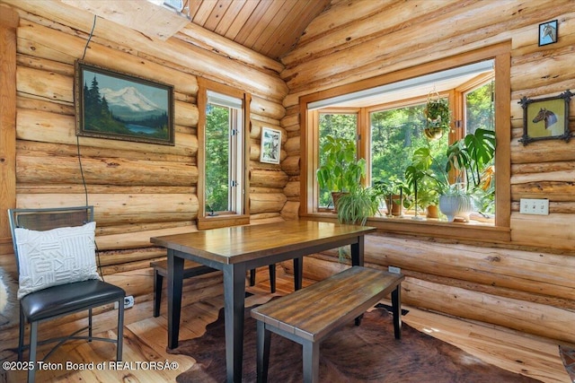 6250 W Paintbrush Trl, Wilson, WY 83014 - dining space featuring healthy amount of natural light, hardwood / wood-style floors, rustic walls, and wood ceiling