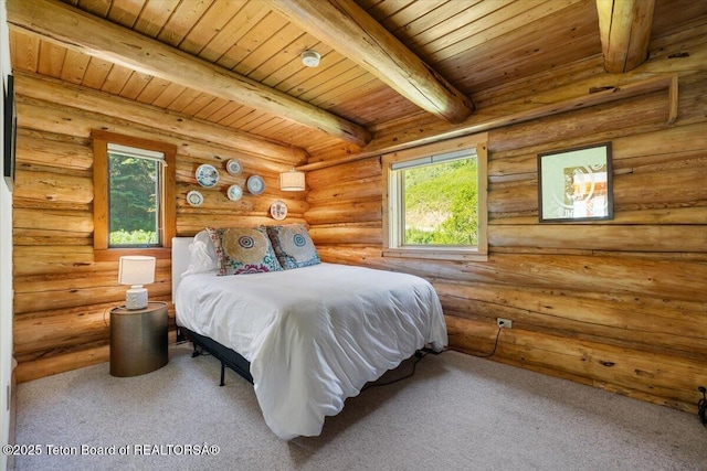 6250 W Paintbrush Trl, Wilson, WY 83014 - carpeted bedroom with a wood ceiling with exposed beams and log walls