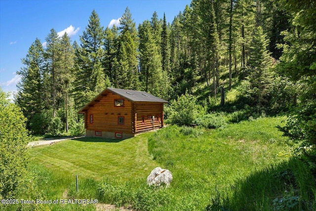 6250 W Paintbrush Trl, Wilson, WY 83014 - view of green lawn with a wooded view