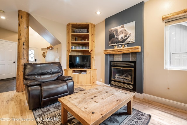 910 Powder Valley Rd Unit 20, Driggs, ID 83422 - living area with light wood-style flooring, a tile fireplace, and recessed lighting