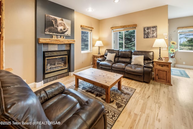 910 Powder Valley Rd Unit 20, Driggs, ID 83422 - living room featuring light wood-style floors, a tiled fireplace, and recessed lighting