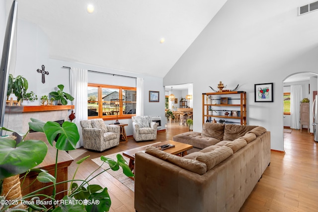 92 Ashley Dr, Alpine, WY 83128 - living room with arched walkways, high vaulted ceiling, plenty of natural light, light wood-style flooring, and recessed lighting