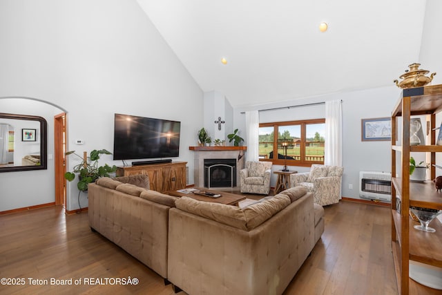 92 Ashley Dr, Alpine, WY 83128 - living area with high vaulted ceiling, heating unit, wood-type flooring, a fireplace, and arched walkways