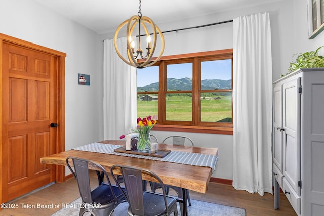 92 Ashley Dr, Alpine, WY 83128 - dining area featuring a chandelier, wood finished floors, and a mountain view