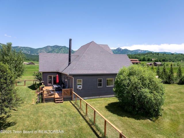 92 Ashley Dr, Alpine, WY 83128 - back of house featuring a deck with mountain view, roof with shingles, and cooling unit