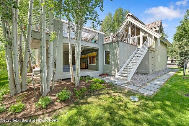 2620 N Fairways Pl W, Wilson, WY 83014 - back of property with a yard, stairs, and a patio area