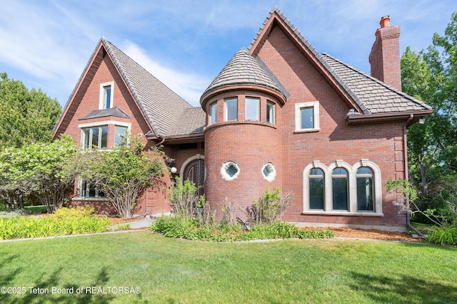 4976 S 49th, Idaho Falls, ID 83406 - view of front of home with brick siding, a front lawn, and a chimney