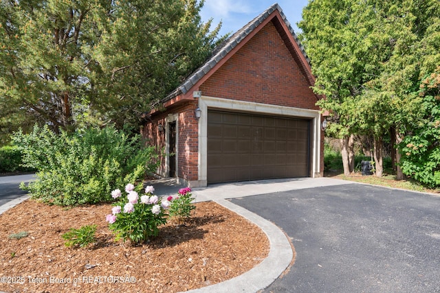 4976 S 49th, Idaho Falls, ID 83406 - view of side of home featuring brick siding, a detached garage, and an outbuilding