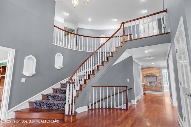 4976 S 49th, Idaho Falls, ID 83406 - stairs featuring wood finished floors, a towering ceiling, recessed lighting, and a fireplace