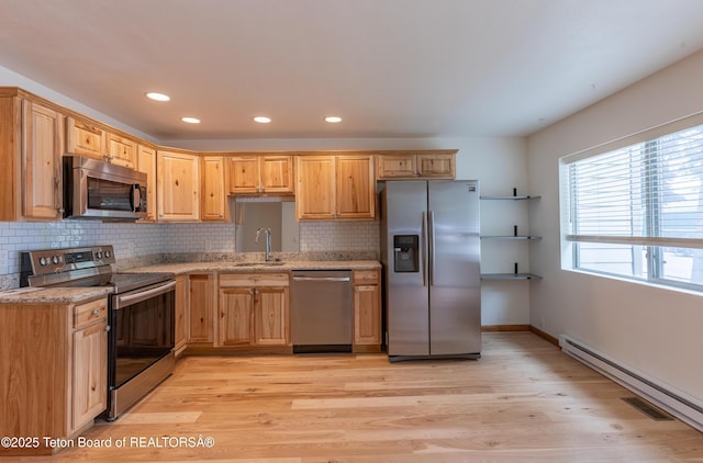 55 Virginian Ln Unit 55-2, Jackson, WY 83002 - kitchen with stainless steel appliances, light wood-style flooring, tasteful backsplash, recessed lighting, and light stone counters