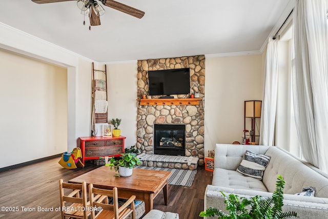 26 Merrimac Trl, Boulder, WY 82923 - living area with a ceiling fan, crown molding, wood finished floors, and a stone fireplace