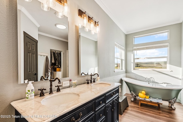 26 Merrimac Trl, Boulder, WY 82923 - bathroom with crown molding, wood finished floors, double vanity, a soaking tub, and a textured wall