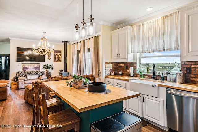 26 Merrimac Trl, Boulder, WY 82923 - kitchen featuring wood counters, stainless steel dishwasher, a breakfast bar area, white cabinets, and crown molding