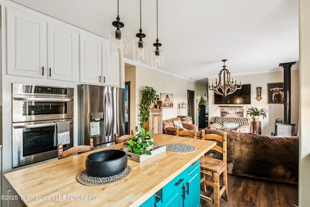 26 Merrimac Trl, Boulder, WY 82923 - kitchen with appliances with stainless steel finishes, wood counters, white cabinetry, open floor plan, and a chandelier